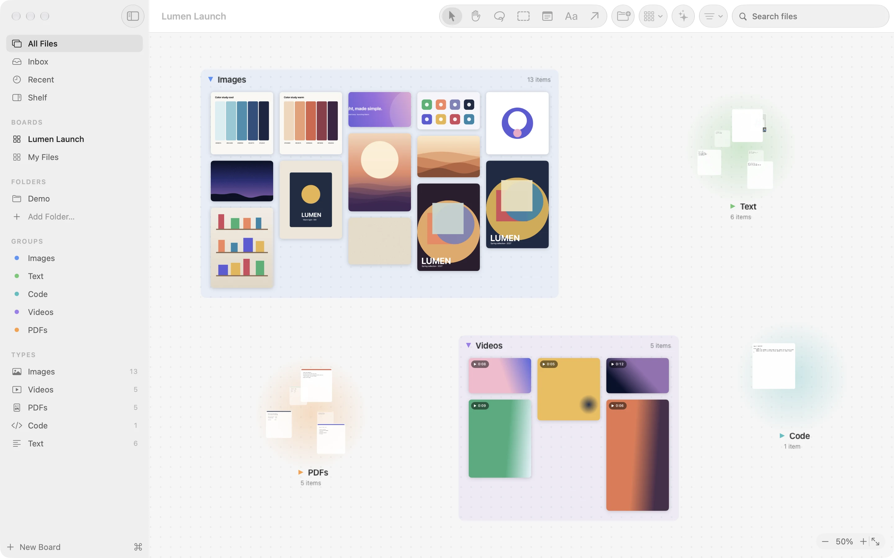 FileCanvas on a Mac: a sidebar of boards, folders, groups, and file types beside a board where images, videos, and documents sit as cards in colored groups, some collapsed into round piles of thumbnails.